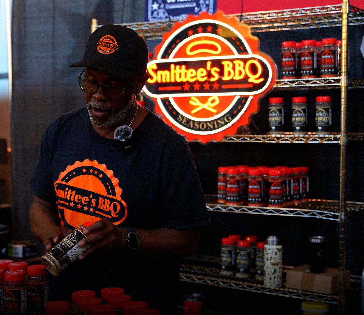 Smittee at the booth holding a jar